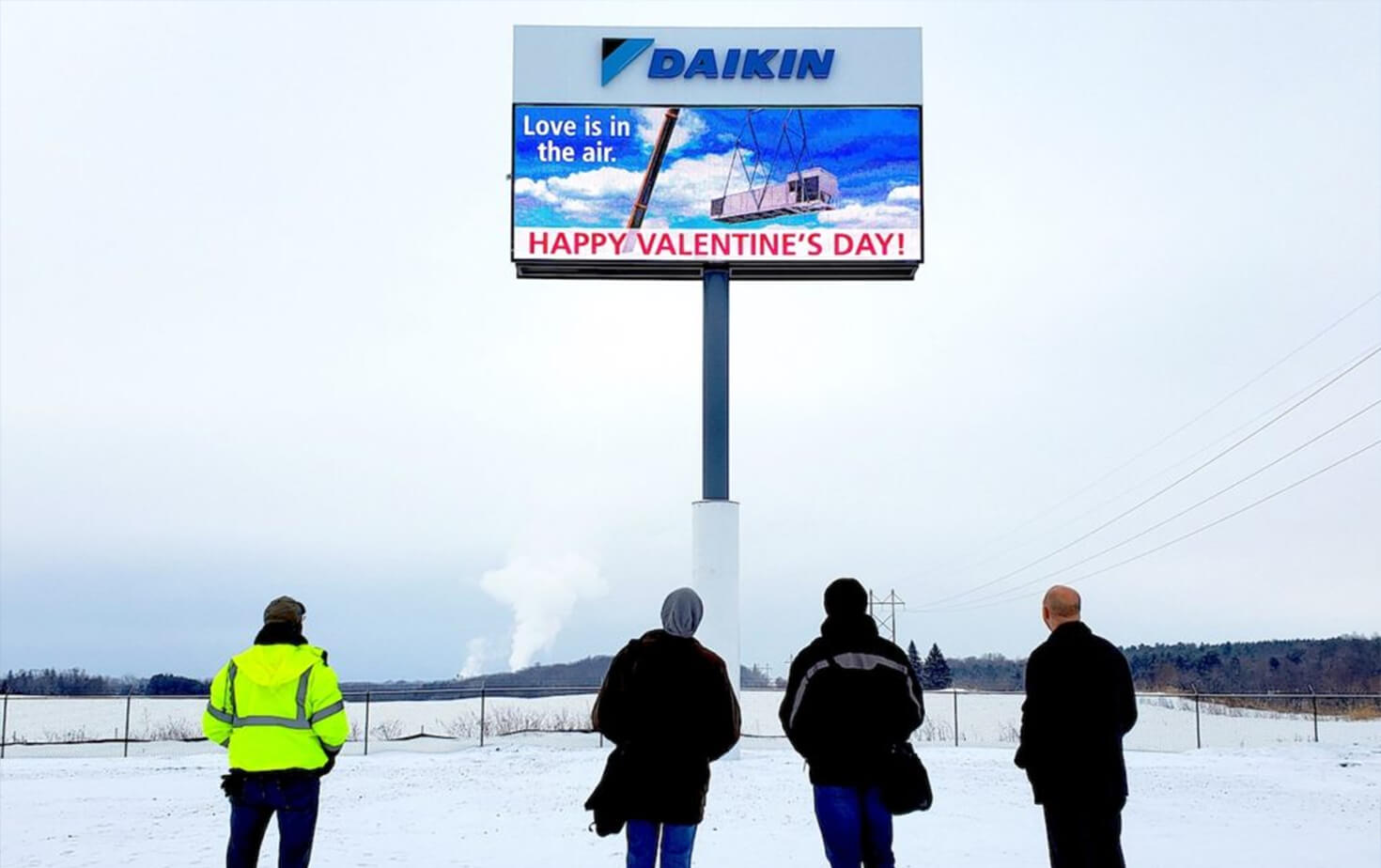 Dakin Applied Americas Fairbault MN Pylon Sign with people in foreground