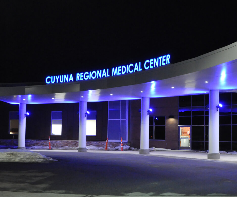 Cuyuna Regional Medical Center entrance illuminated at night with color changing led letters in Crosby MN