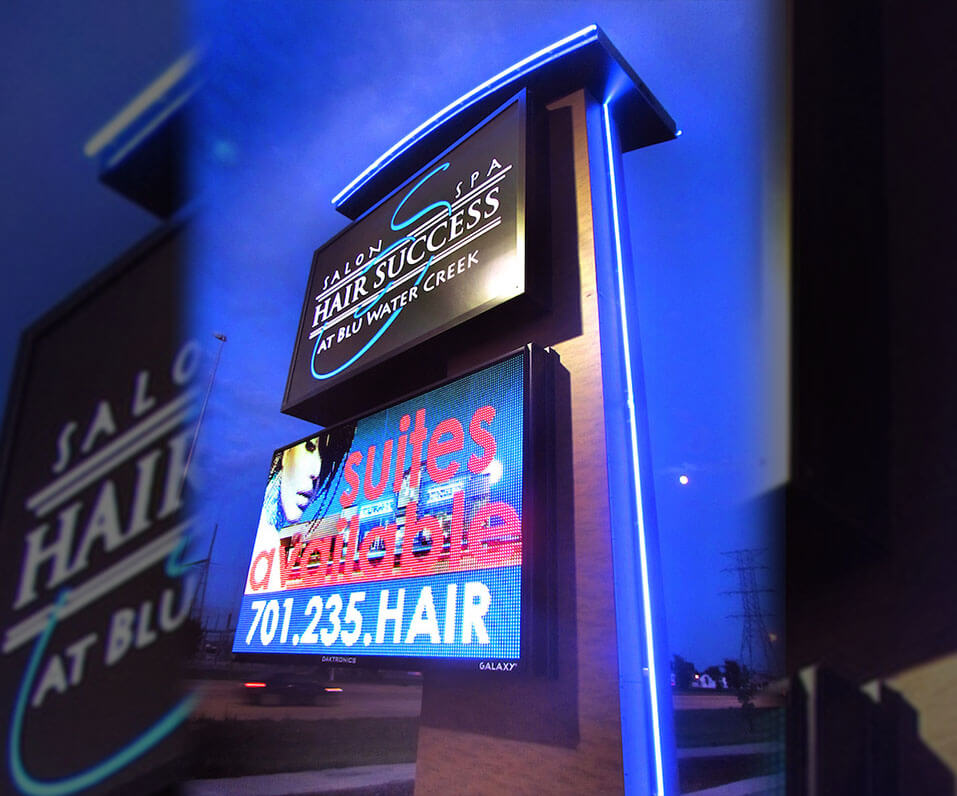 Hair Success Blu Creek Pylon Sign at Night with blue accent lighting custom cladding and Daktronics EMC