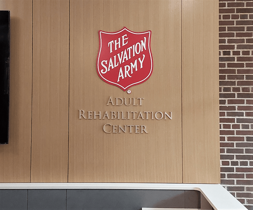 Interior Logo behind reception area for the salvation army adult rehabilitation center 