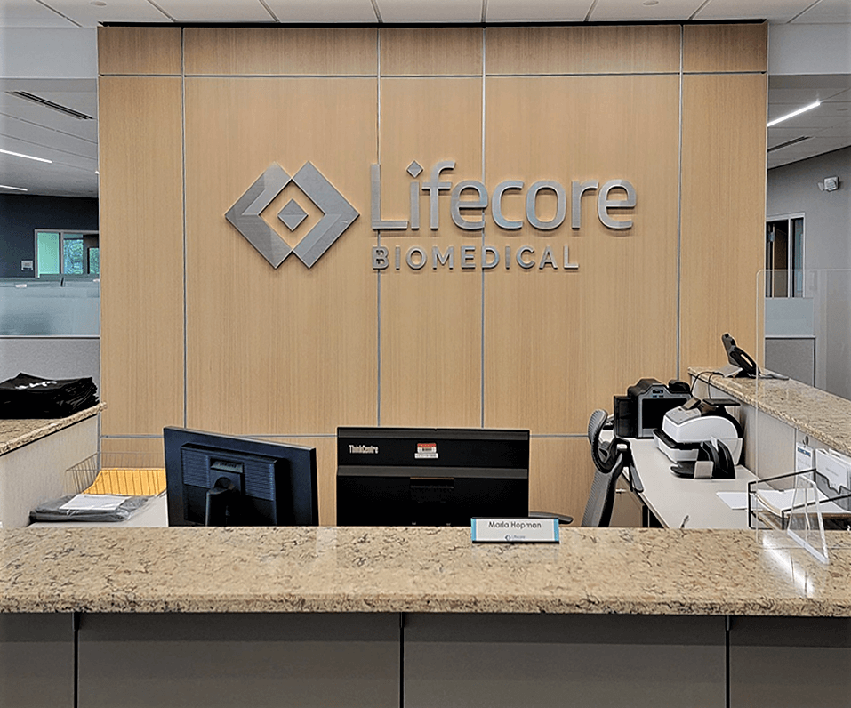 Lifecore Biomedical Interior Logo on wood wall behind reception area