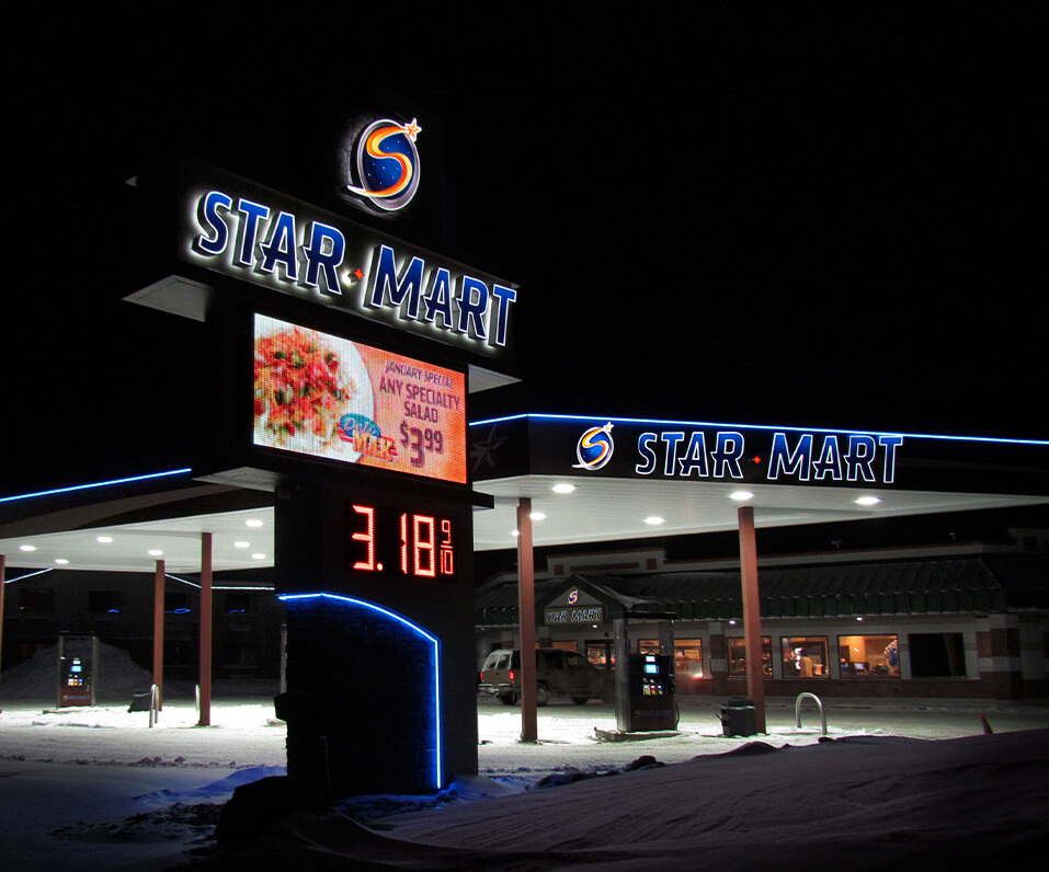 Star Mart Mahnomen MN signs at night with digital display and gas pricer edge lit canopy