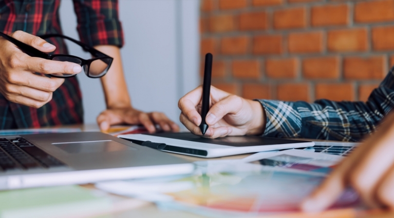 Co-worker working with graphic design in office room together